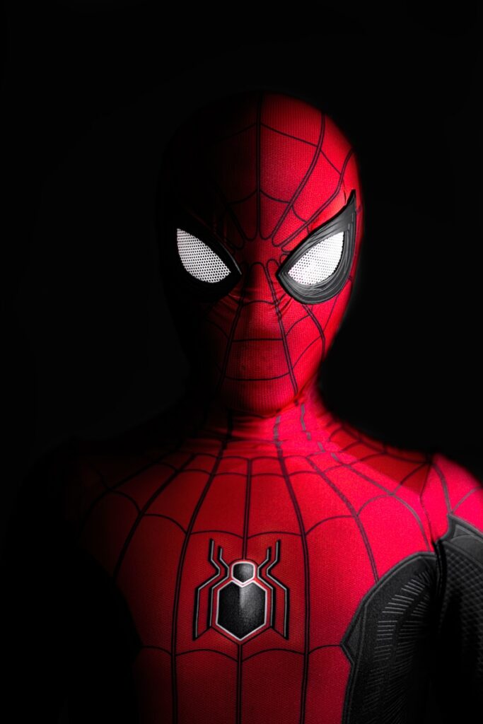 a close up of a spider man with glowing eyes